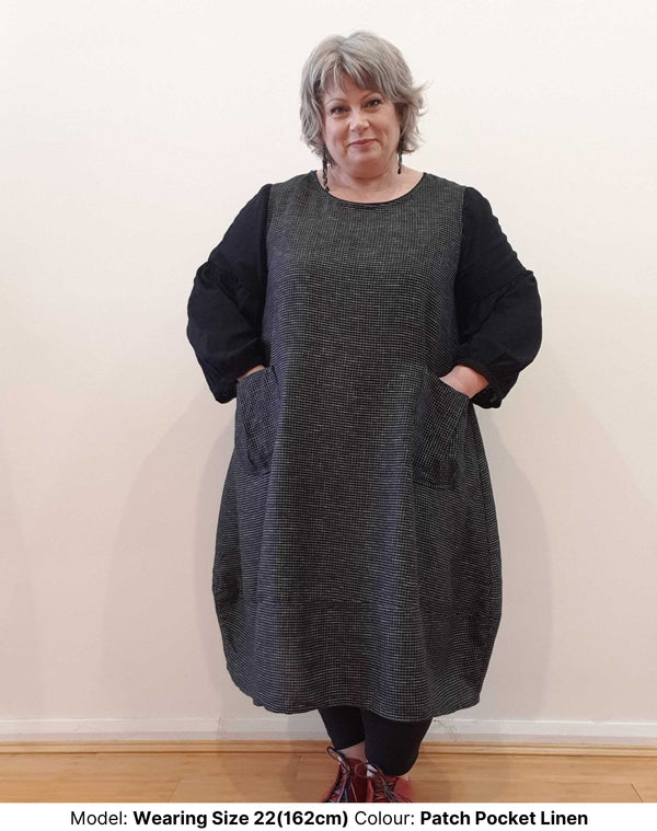 Front view of plus size model wearing size 22 linen and cotton fibre tunic hand made in Melbourne. Model is wearing sleeveless dress over the Black Sparrow Blouse in Cotton from Chasing Springtime, also in size 22.