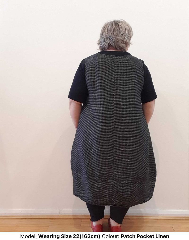 Back view of curve model wearing plus size midi dress in natural fibres. It is being worn over the cotton stretch plus size short-sleeve best-tee. Both garments are size 22, made in Australia and available from Chasing Springtime.