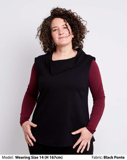 Front view of size 14 model dressed for work in a womens plus size vest with collar in black Low pill ponte.