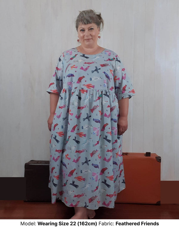 model wearing size 22 plus size feathered prints cotton lawn dress with extra wide sleeves, round neck and pockets
