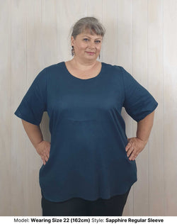 Size 22 model wears  plus size curvy long navy blue sapphire linen blouse with elbow length short sleeves sleeves to fit larger upper arms and biceps available in sizes 14 to 26