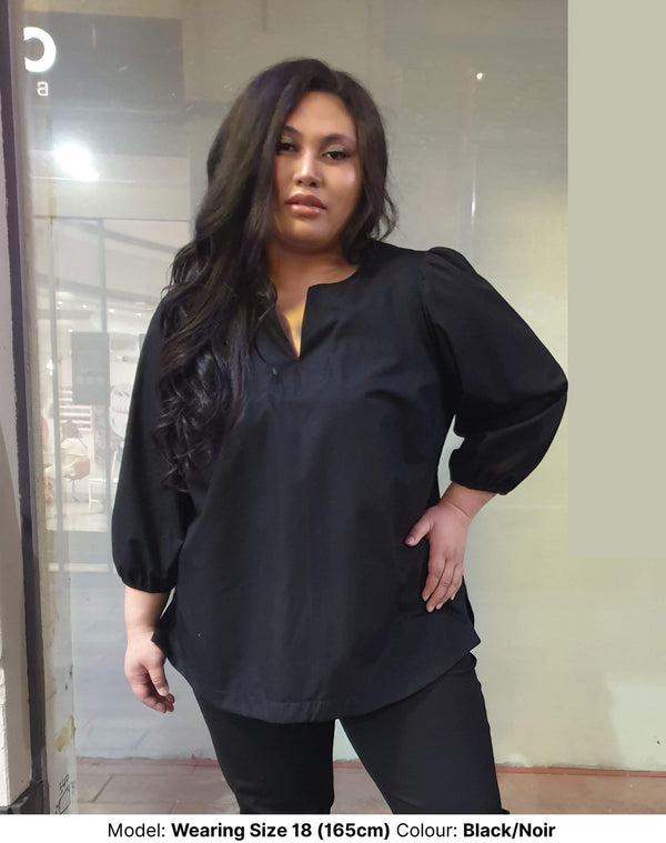Plus size woman wearing black/noir work blouse