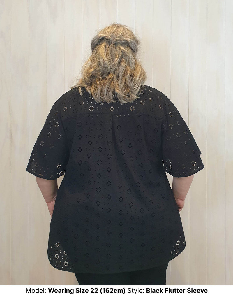 Back view of Size 22 model wearing black cotton broderie anglaise extra long blouse with wide short sleeves available in sizes 14 to 26 ethically made in Australia